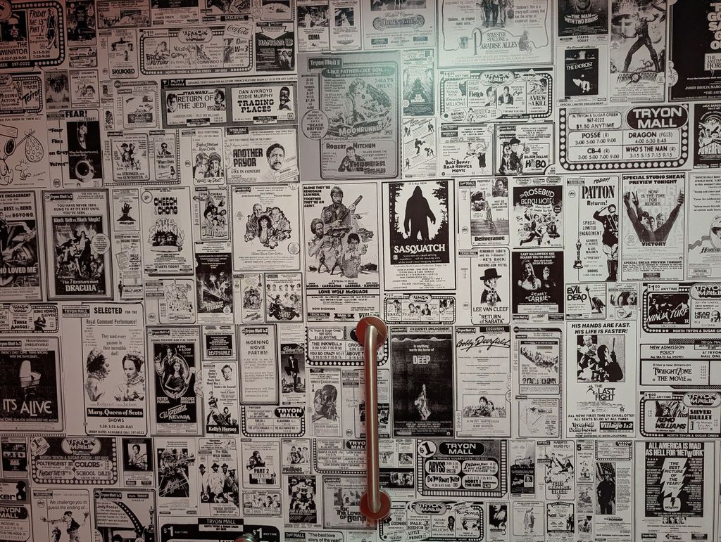 The bathroom wallpaper uses newspaper clippings from local theaters.